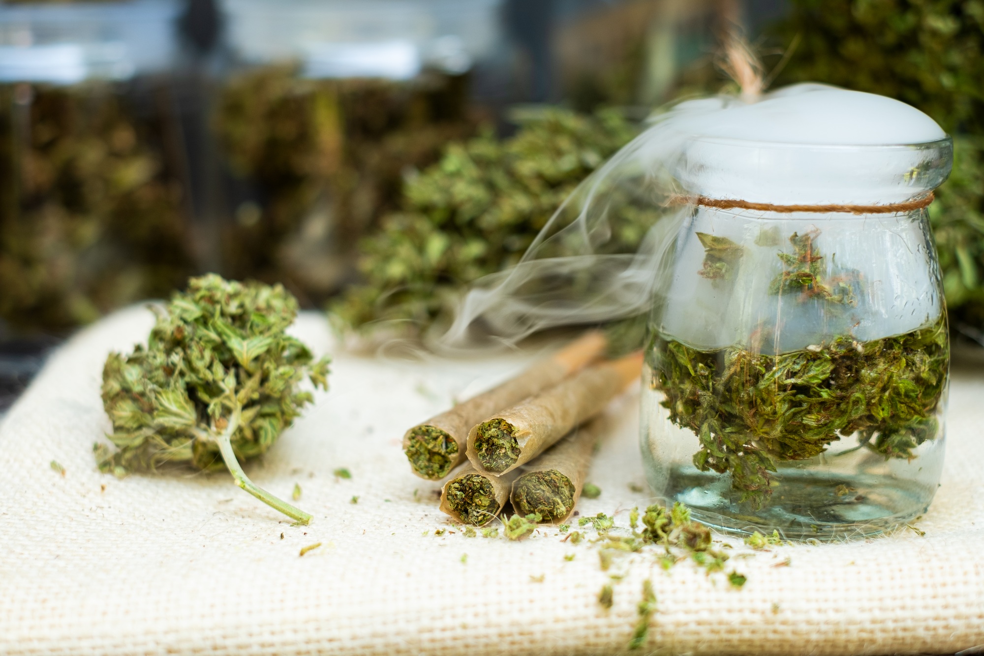 Pre-Rolled cones for smoking cannabis with cannabis indica in a clear bottle